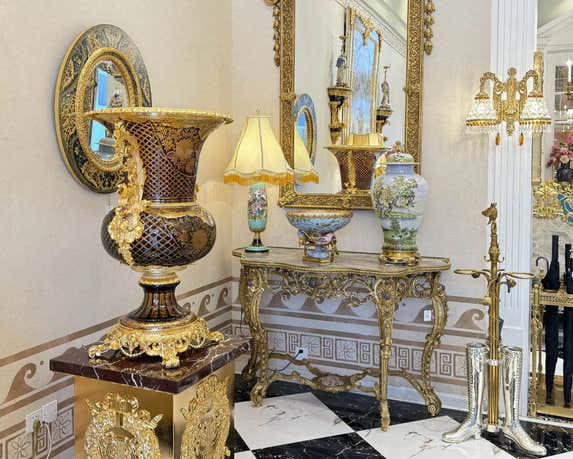 Homedor Decorative interior collection with ornate furniture, mirrors, and vases in a luxurious setting.