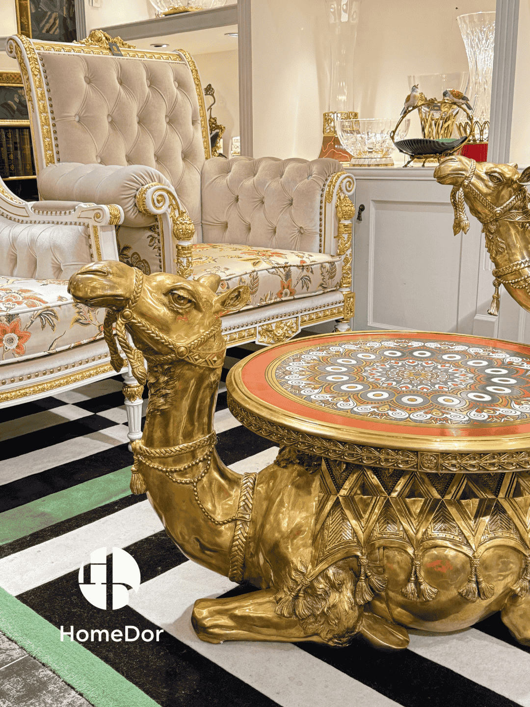 Luxurious gold table with intricate design in a stylish room, featuring HomeDor branding.
