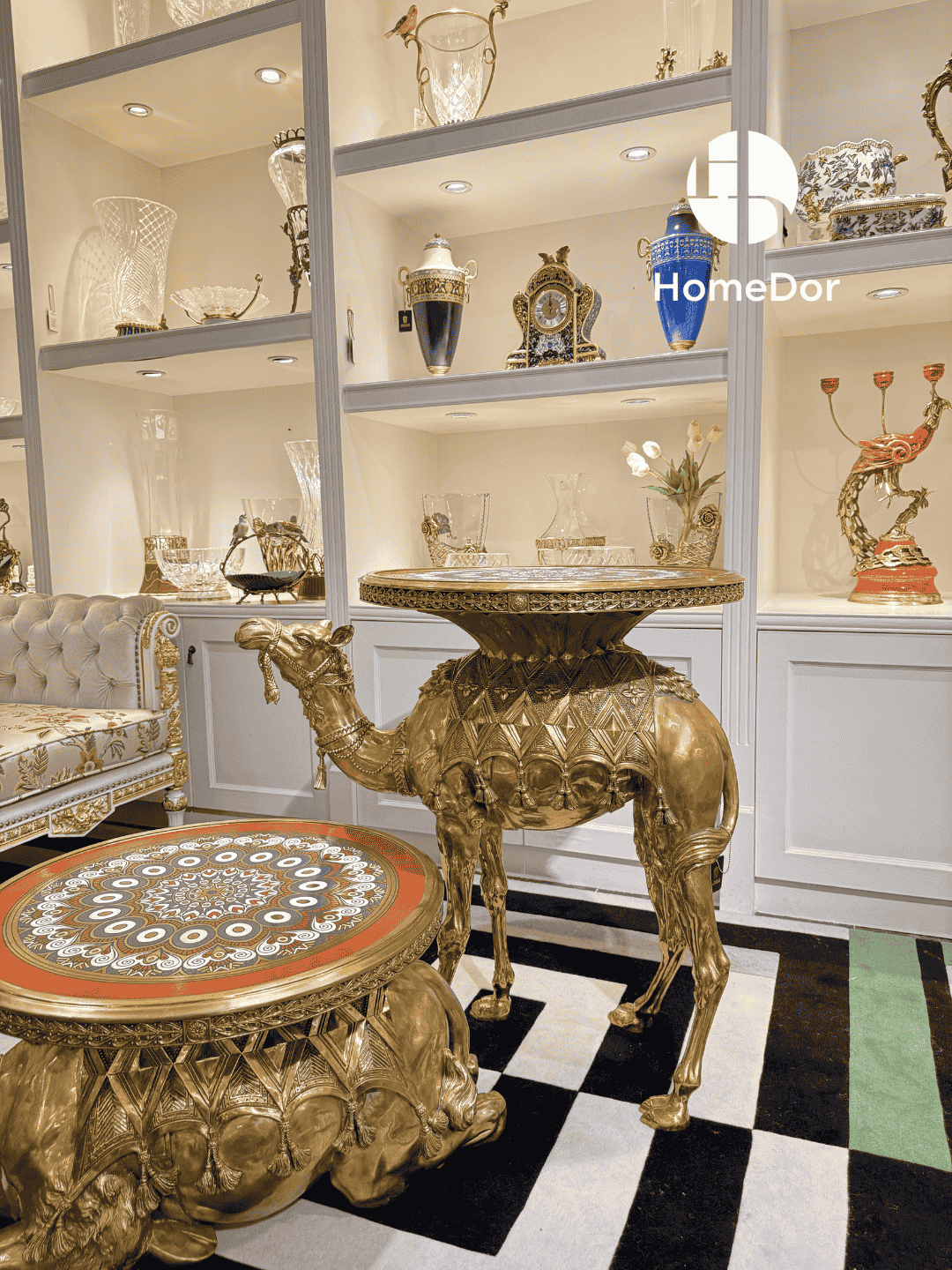 Decorative camel-shaped table in a showroom setting with 'HomeDor' branding.