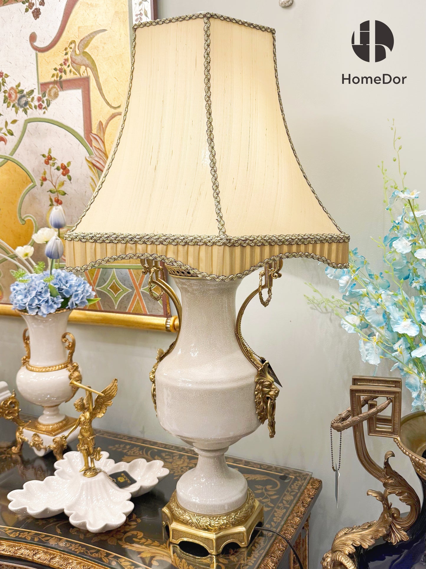 It pairs with a soft beige fabric shade, trimmed with intricate braided edging and tassel details