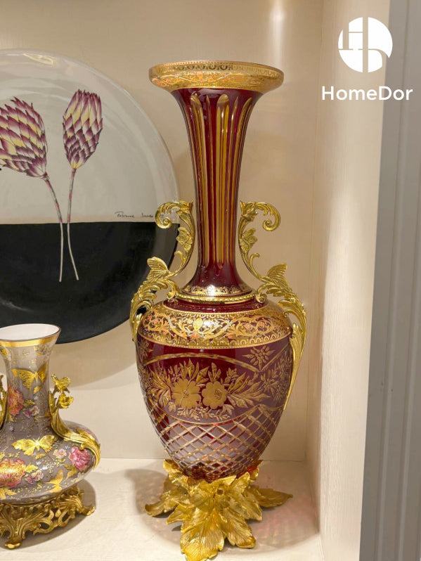 The Aurora Glass Imperial Sunset Ensemble captures the warmth and splendor of a palace illuminated by the final golden light of day.

Comprising a monumental amphora, a decorative amphora, and a grand ceremonial tazza, the ensemble showcases the extraordinary artistry of Aurora Glass through a radiant palette of amber, ruby, and sunlit gold. Delicate floral etching, intricate gilt mounts, and luminous color transitions create a remarkable interplay of light and ornament, transforming each piece into a jewel