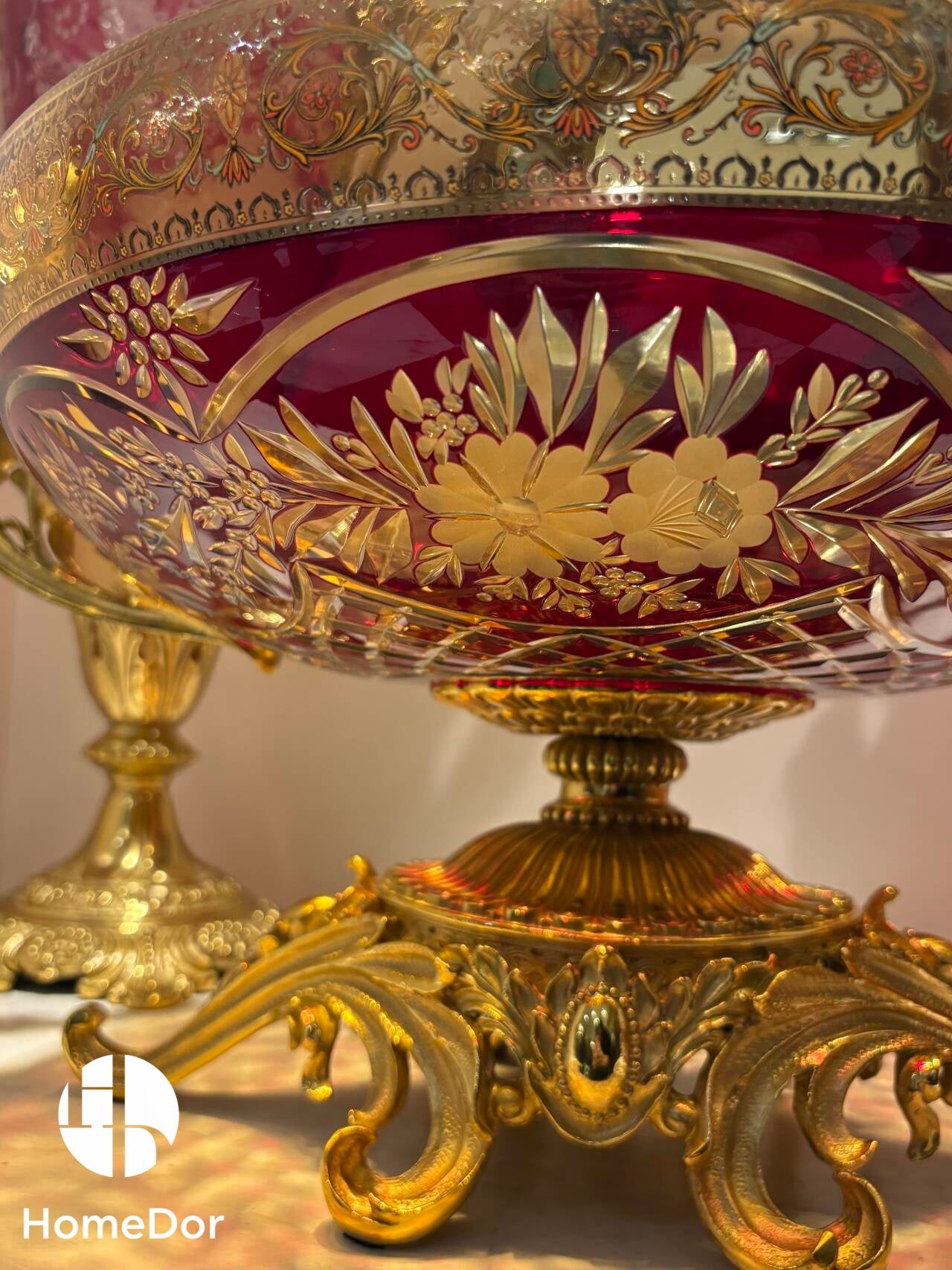 The Aurora Glass Imperial Sunset Ensemble captures the warmth and splendor of a palace illuminated by the final golden light of day.

Comprising a monumental amphora, a decorative amphora, and a grand ceremonial tazza, the ensemble showcases the extraordinary artistry of Aurora Glass through a radiant palette of amber, ruby, and sunlit gold. Delicate floral etching, intricate gilt mounts, and luminous color transitions create a remarkable interplay of light and ornament, transforming each piece into a jewel