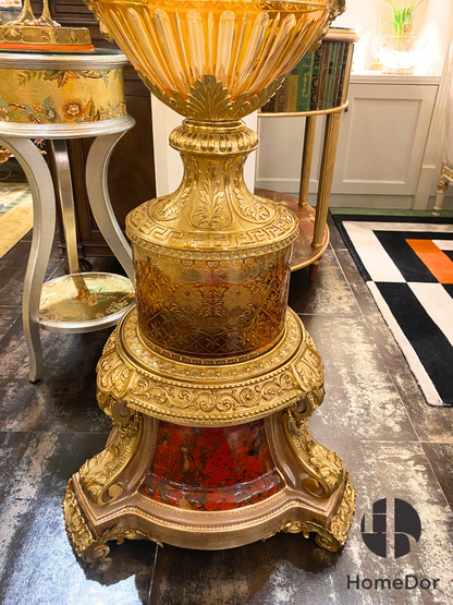 Rising upon an architectural pedestal and crowned with extraordinary detail, the amphora possesses the presence of a ceremonial object—part sculpture, part vessel, and entirely unforgettable. Whether displayed in a grand foyer, formal salon, or collector's interior, it commands attention through its scale, artistry, and sense of imperial grandeur.

More than a vase, it is a monument to decorative art.