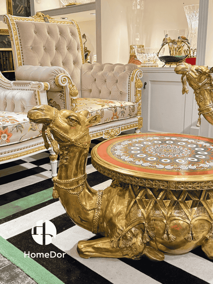 Luxurious gold table with intricate design in a stylish room, featuring HomeDor branding.