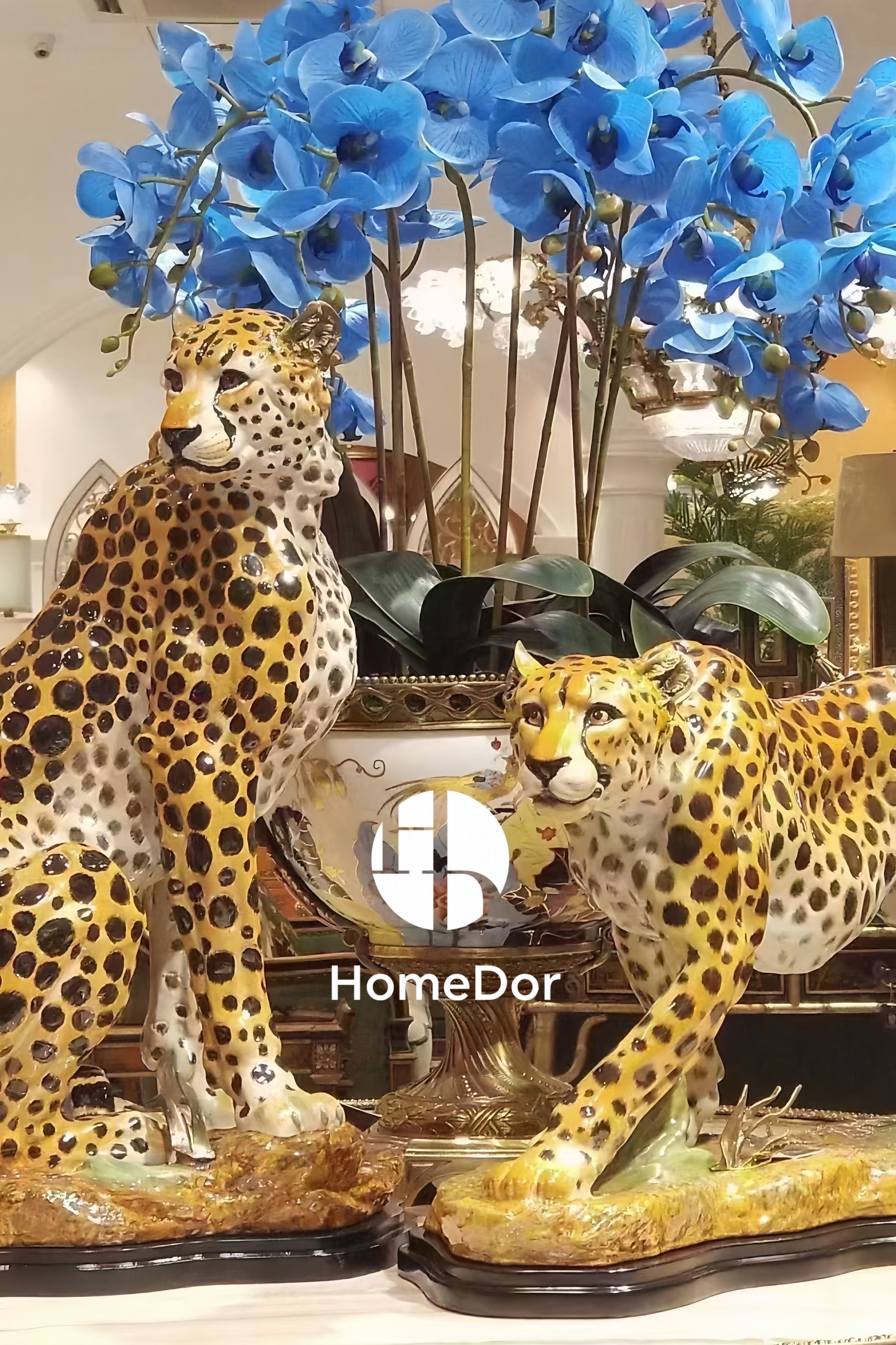Two ceramic cheetah statues with blue flowers