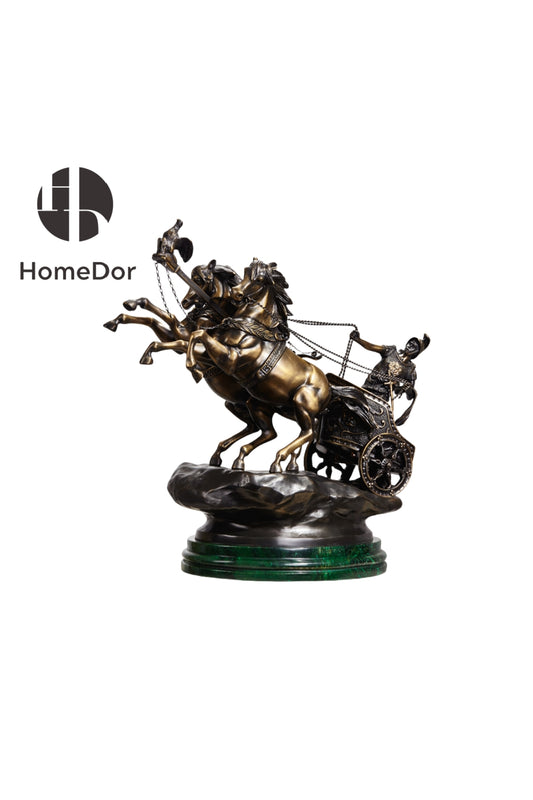 Two horses rear mid-stride as a helmeted charioteer leans into the reins behind them, bronze patina picked out in gilt along the harness and wheel. The chariot rises from a rough-hewn rock base, set on green marble that gives the piece real collector's weight.

The form draws on the Neoclassical bronzes 19th-century travelers brought home from Rome and Pompeii — Grand Tour souvenirs of classical antiquity, cast for a library or a mantel.

At this scale, it anchors a room rather than accents it — a centerpie