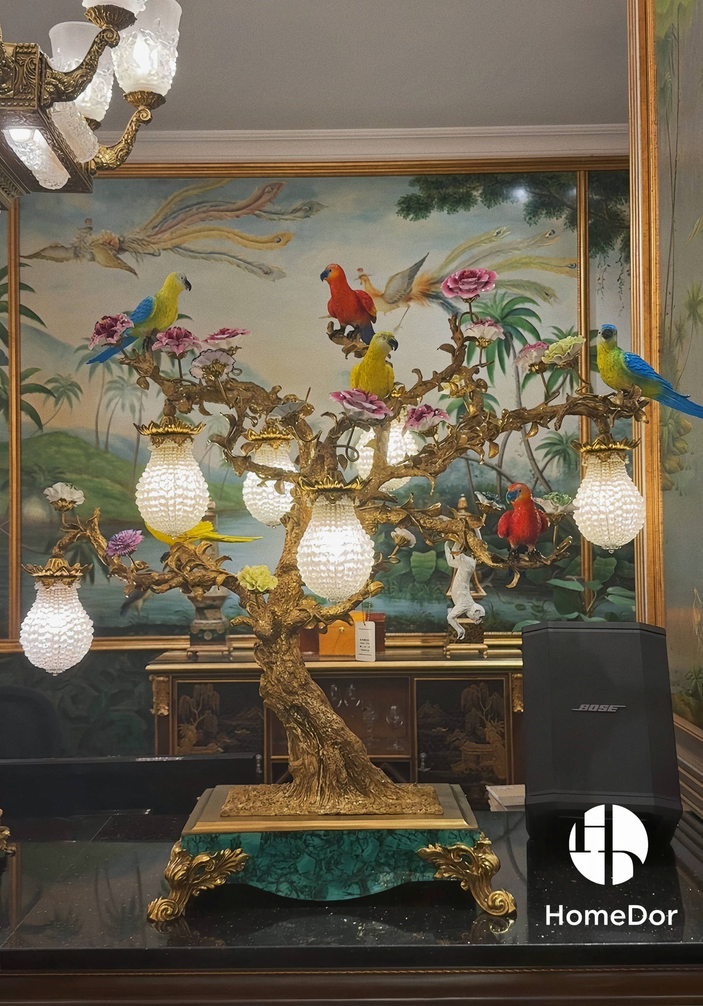 a masterpiece that blends opulent craftsmanship with vibrant artistic detail. Featuring vividly colored parrots and blooming florals perched on an intricately sculpted bronze tree, this lamp is adorned with crystal-encrusted lanterns and set atop a malachite-inspired base.Crafted from copper, high-temperature porcelain, and malachite accents, it exudes a sense of royal elegance, making it a focal point in living rooms, bedrooms, or luxury lounges. The interplay of bronze, crystal, and vivid hues brings a to