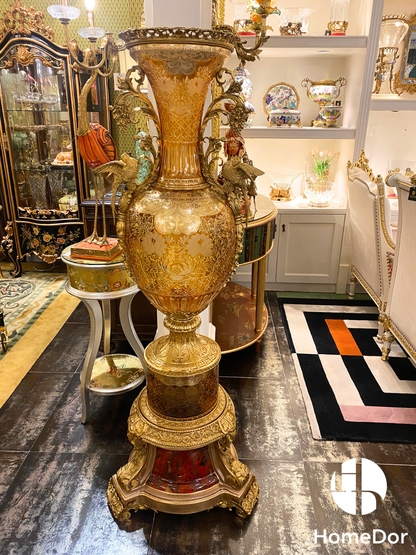 Rising with the grandeur of a palace monument, this Imperial Amber Glass Monumental Amphora is designed not merely to decorate a room, but to define it.