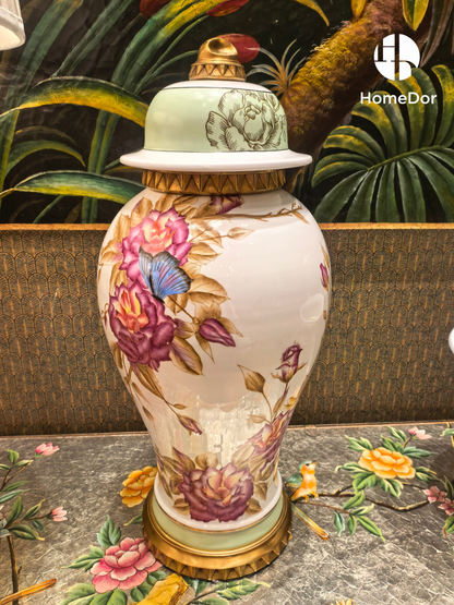 Porcelain lidded urn with pink roses, blue butterflies, and gold fluted base
