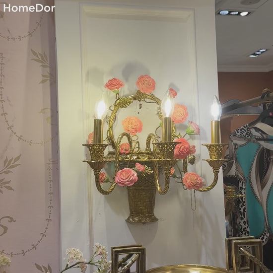 This beautiful pink floral brass wall sconce is rooted in New Spanish aesthetic influences, it acts as both a functional light source and a decorative focal point. Perfect for spaces leaning into rustic romance, classic vintage, or Mediterranean-inspired styles, this sconce turns empty walls into captivating, inviting features.
