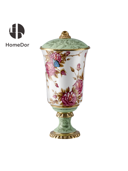 Porcelain lidded urn with pink roses, blue butterflies, and gold fluted base